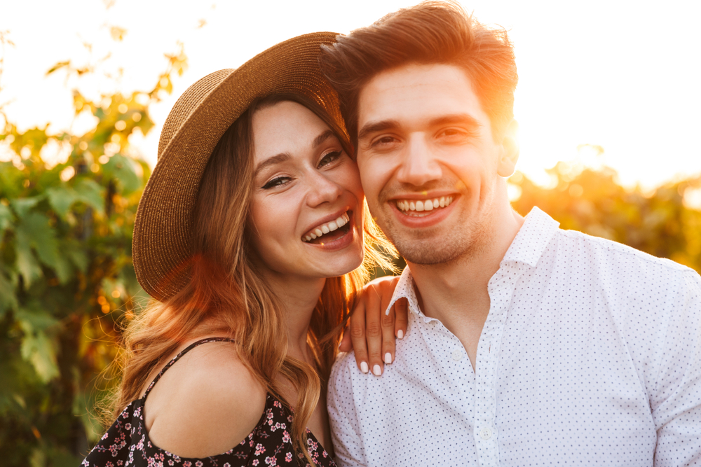 Happy couple with healthy smiles after dental care in Spring TX