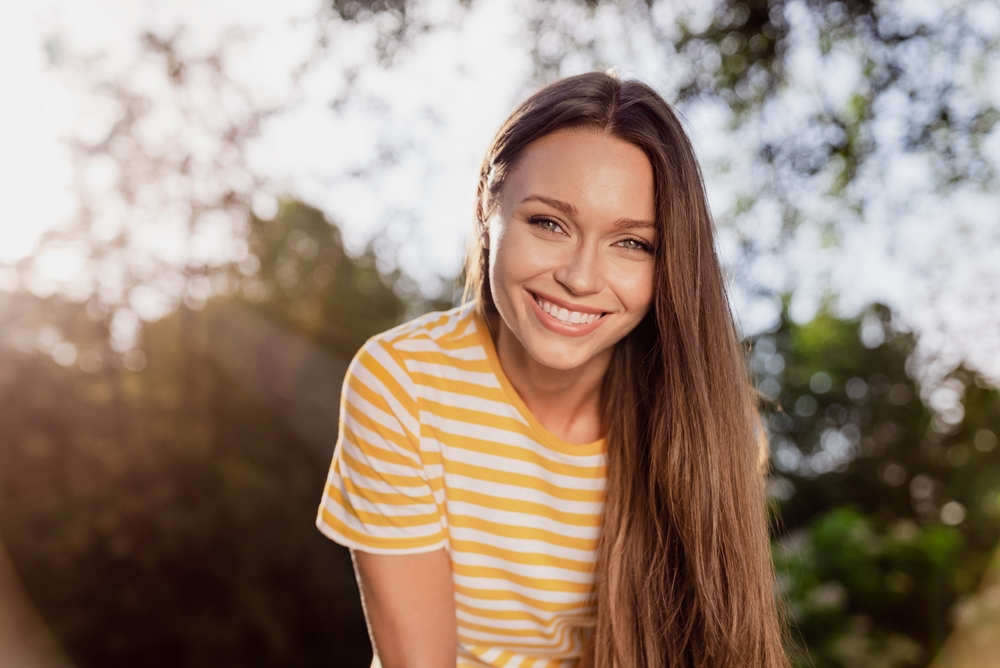 Young woman with confident smile after cosmetic dental treatment in Spring TX