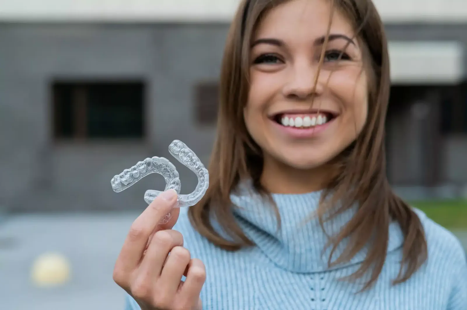 Patient showing clear aligners for orthodontic treatment in Spring TX